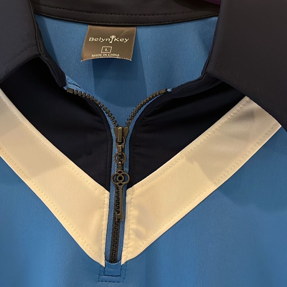 Blue Sleeveless golf Top with navy and White Accents. - Picture 2 of 5